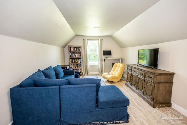 living room with lofted ceiling and light hardwood / wood-style floors