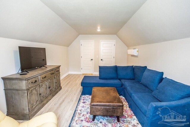 living room featuring light wood-type flooring and lofted ceiling