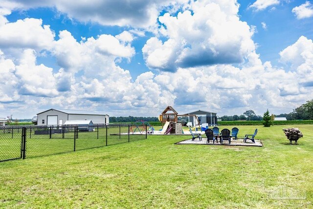 view of yard featuring an outdoor fire pit and a playground