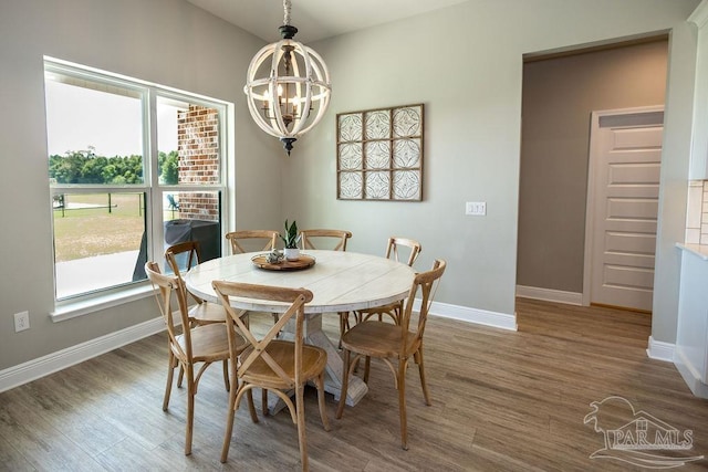 dining room with an inviting chandelier and hardwood / wood-style flooring