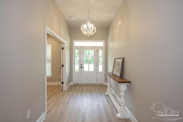 entryway with a notable chandelier and light wood-type flooring