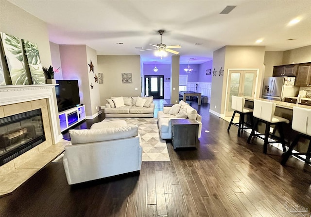 2924 Sundance Ln, Cantonment, FL 32533 - living area with dark wood finished floors, a tiled fireplace, and a ceiling fan