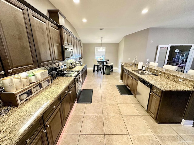 2924 Sundance Ln, Cantonment, FL 32533 - kitchen with appliances with stainless steel finishes, a chandelier, light stone counters, light tile patterned floors, and dark brown cabinetry
