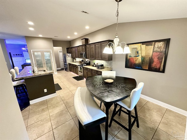 2924 Sundance Ln, Cantonment, FL 32533 - dining room featuring a chandelier, recessed lighting, light tile patterned floors, and lofted ceiling