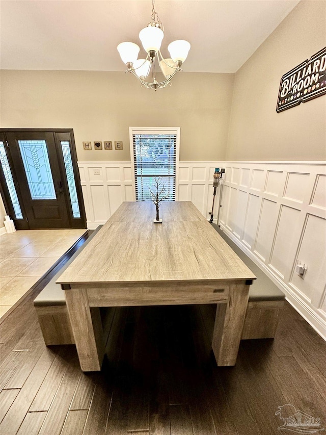 2924 Sundance Ln, Cantonment, FL 32533 - unfurnished dining area with a decorative wall, a chandelier, dark wood-type flooring, and a wainscoted wall