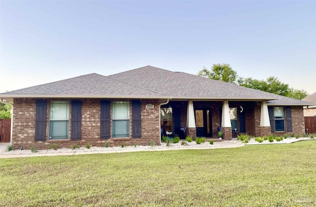 2924 Sundance Ln, Cantonment, FL 32533 - view of front of home featuring brick siding, a front lawn, roof with shingles, and a porch