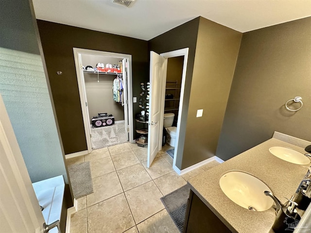 2924 Sundance Ln, Cantonment, FL 32533 - full bathroom with vanity, a walk in closet, and tile patterned flooring