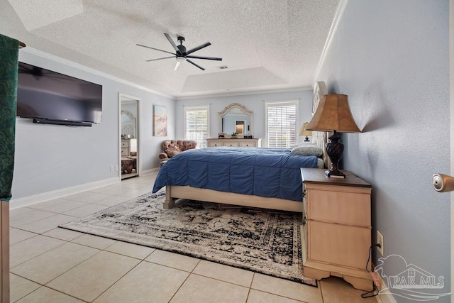 tiled bedroom with a raised ceiling, ceiling fan, crown molding, and a textured ceiling