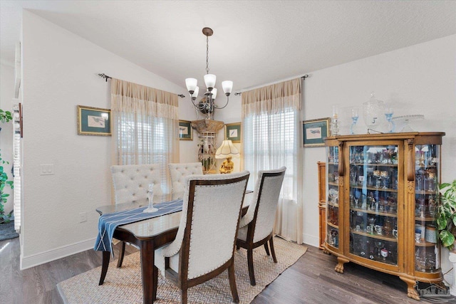 6135 Redberry Dr, Gulf Breeze, FL 32563 - dining room with a chandelier, wood finished floors, and lofted ceiling