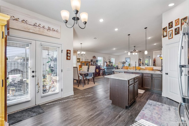 6135 Redberry Dr, Gulf Breeze, FL 32563 - kitchen with a chandelier, plenty of natural light, french doors, dark brown cabinetry, and recessed lighting