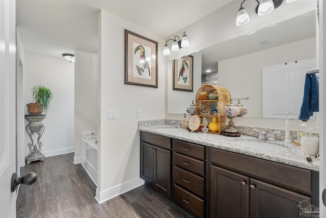 6135 Redberry Dr, Gulf Breeze, FL 32563 - full bathroom with wood finished floors, double vanity, and a garden tub