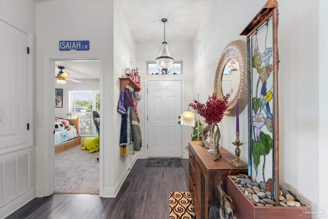 6135 Redberry Dr, Gulf Breeze, FL 32563 - foyer entrance featuring dark wood-style flooring and a chandelier