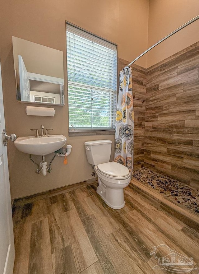 9873 Chumuckla Springs Rd, Jay, FL 32565 - full bath with wood finished floors, a sink, baseboards, toilet, and tiled shower