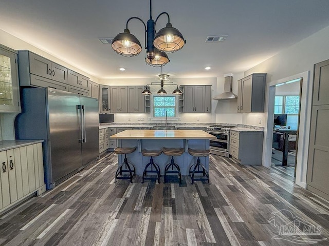 9873 Chumuckla Springs Rd, Jay, FL 32565 - kitchen featuring stainless steel appliances, gray cabinetry, and wall chimney exhaust hood