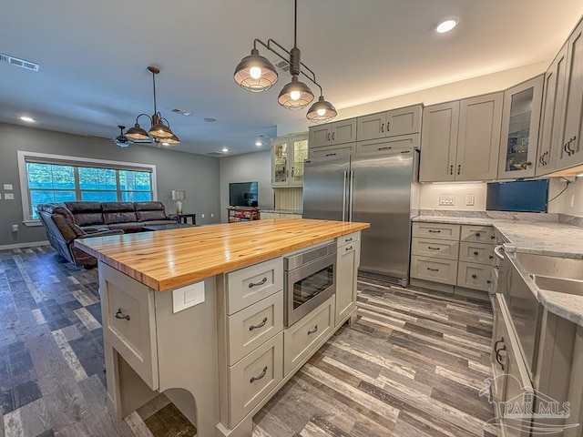 9873 Chumuckla Springs Rd, Jay, FL 32565 - kitchen featuring visible vents, built in appliances, wooden counters, dark wood-type flooring, and recessed lighting