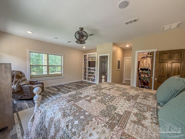 9873 Chumuckla Springs Rd, Jay, FL 32565 - bedroom featuring baseboards, wood finished floors, a spacious closet, and visible vents