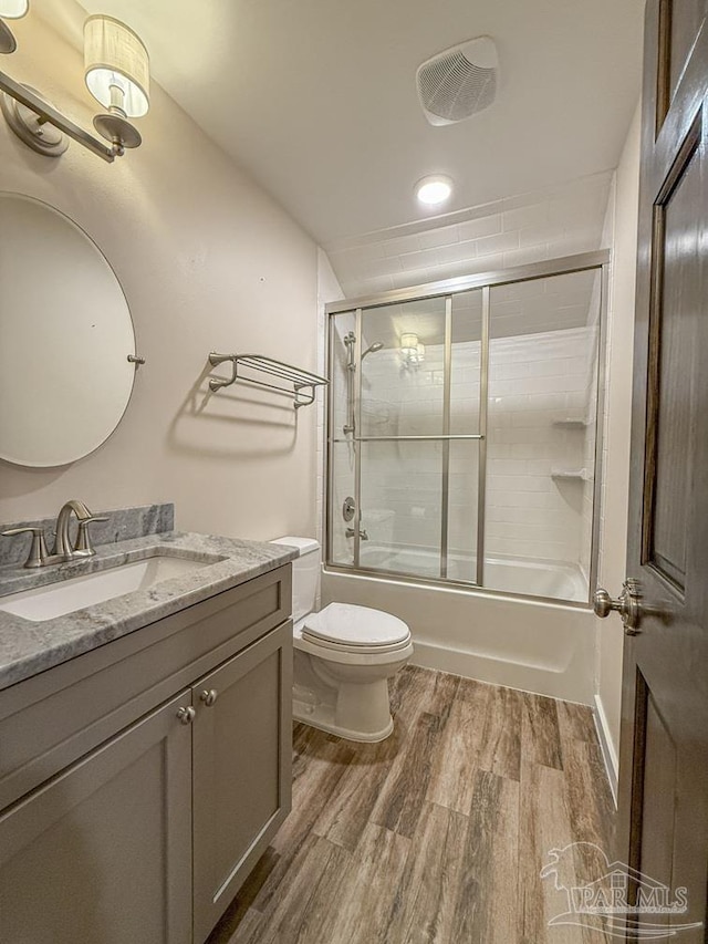 9873 Chumuckla Springs Rd, Jay, FL 32565 - full bath featuring vanity, toilet, combined bath / shower with glass door, wood finished floors, and visible vents