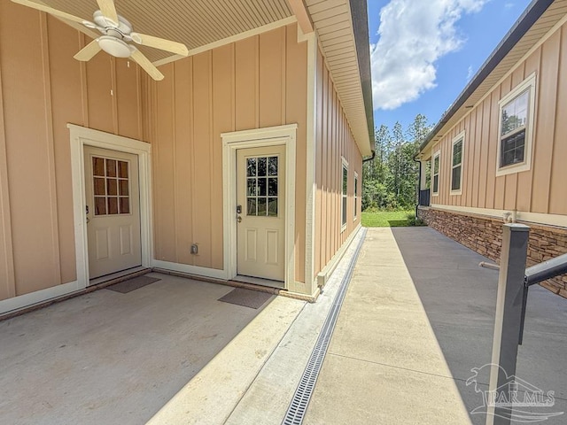 9873 Chumuckla Springs Rd, Jay, FL 32565 - property entrance featuring board and batten siding, a patio, and a ceiling fan