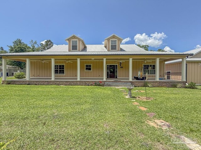 9873 Chumuckla Springs Rd, Jay, FL 32565 - view of front of home featuring board and batten siding, ceiling fan, a front lawn, and metal roof