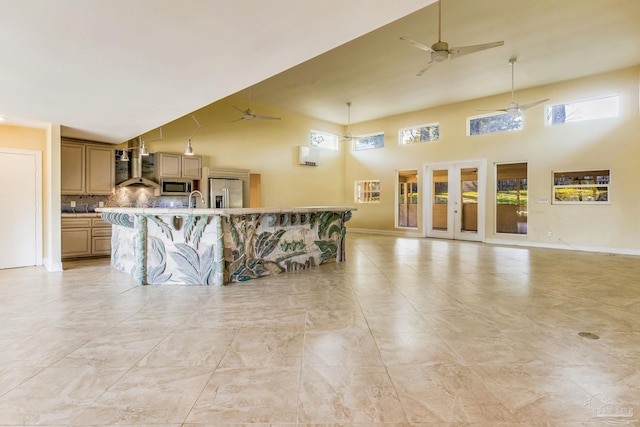 living room with sink and a towering ceiling