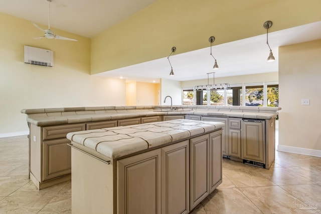 kitchen with lofted ceiling, sink, hanging light fixtures, ceiling fan, and a kitchen island