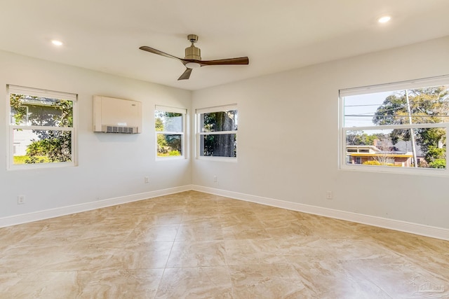 empty room featuring ceiling fan and plenty of natural light