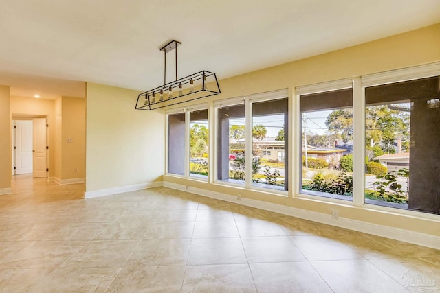 unfurnished dining area featuring plenty of natural light and light tile patterned floors