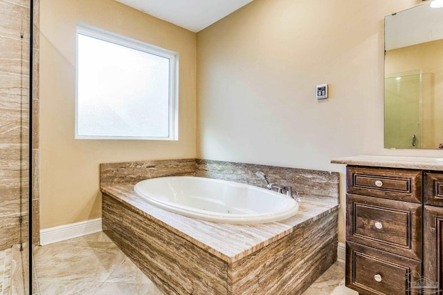 bathroom featuring vanity and a relaxing tiled tub