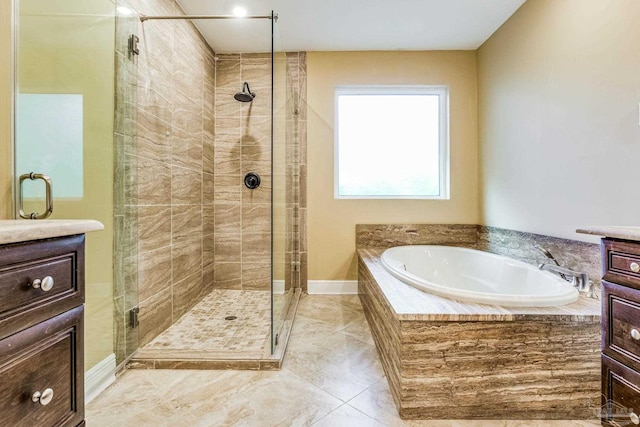 bathroom featuring vanity and independent shower and bath