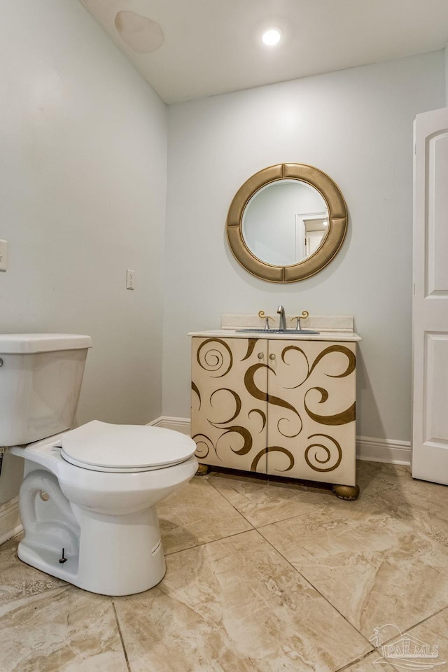 bathroom featuring vanity and toilet