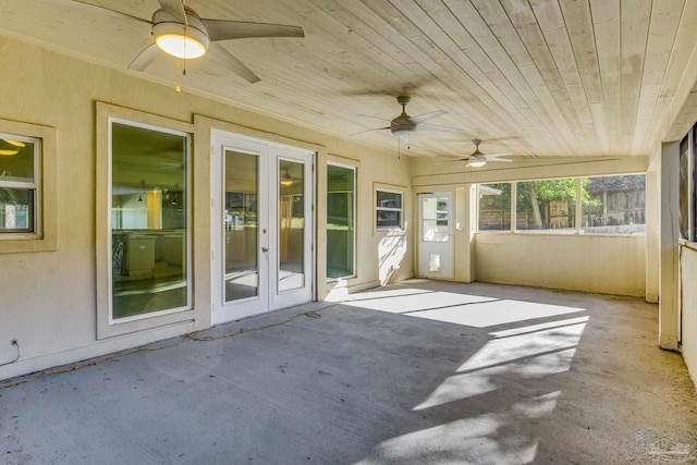 unfurnished sunroom with wood ceiling and french doors