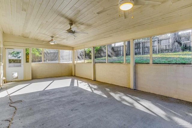 unfurnished sunroom with vaulted ceiling, a wealth of natural light, and wooden ceiling