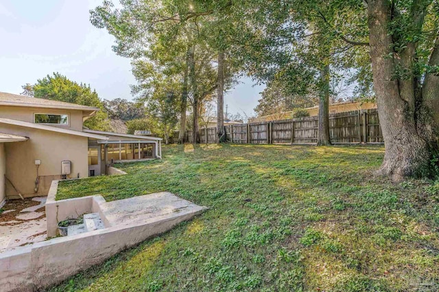 view of yard with a sunroom