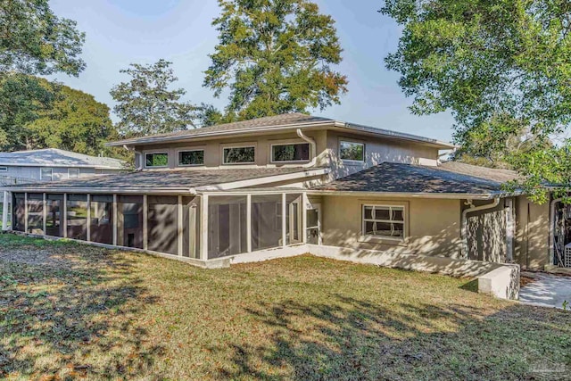 back of house featuring a yard and a sunroom