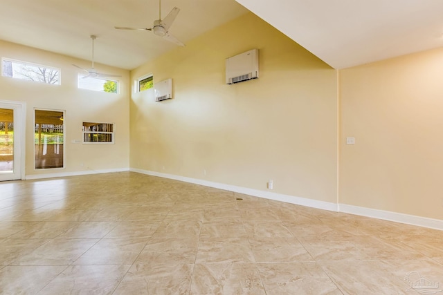 empty room with ceiling fan and a towering ceiling