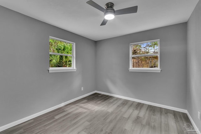 unfurnished room with light hardwood / wood-style floors, ceiling fan, and plenty of natural light