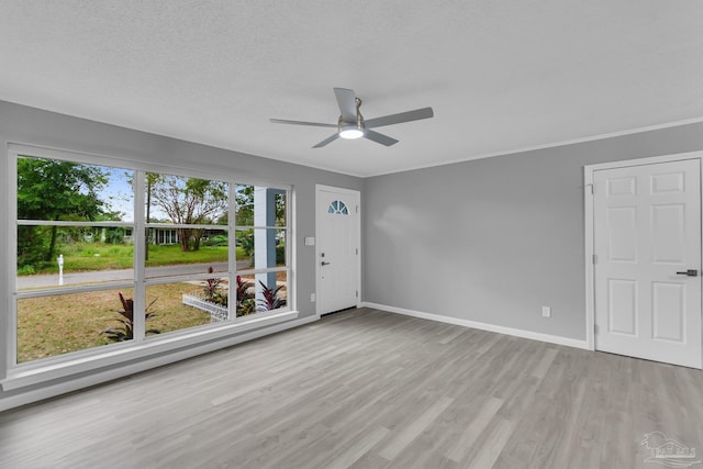 unfurnished room featuring ceiling fan, a textured ceiling, and light hardwood / wood-style flooring