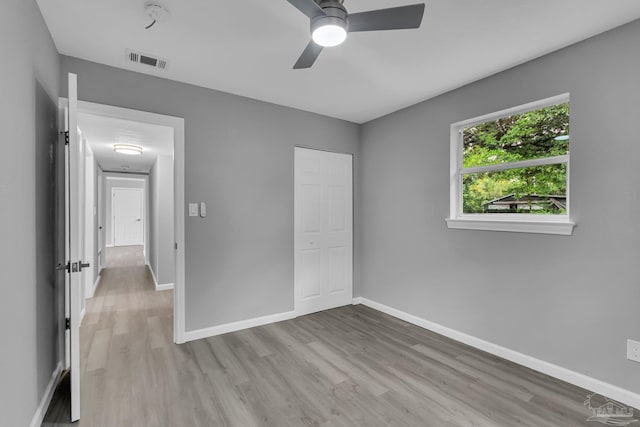 unfurnished bedroom featuring ceiling fan and light wood-type flooring