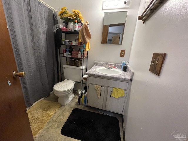 bathroom featuring curtained shower, tile patterned flooring, vanity, and toilet