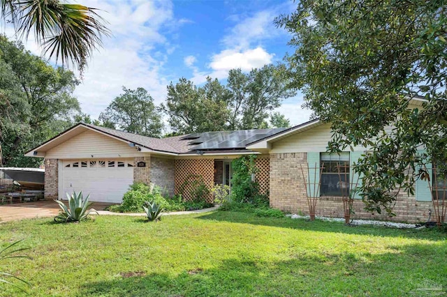 single story home featuring brick siding, a front lawn, an attached garage, and roof mounted solar panels