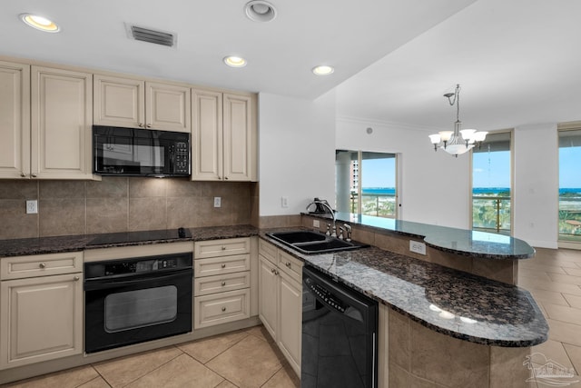 kitchen featuring decorative light fixtures, kitchen peninsula, black appliances, and sink