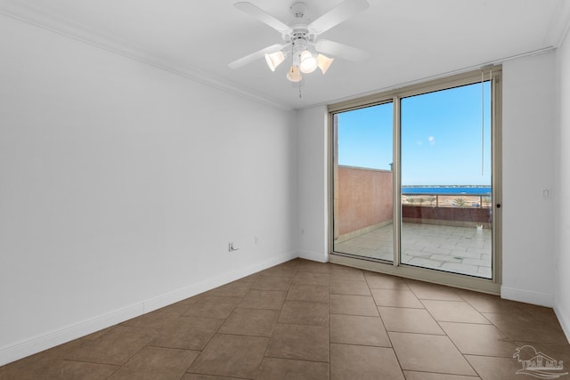 tiled spare room featuring ornamental molding and ceiling fan