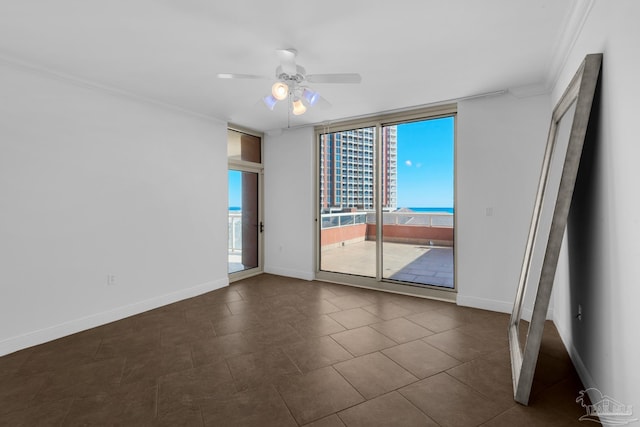 spare room featuring ornamental molding, ceiling fan, and a wall of windows