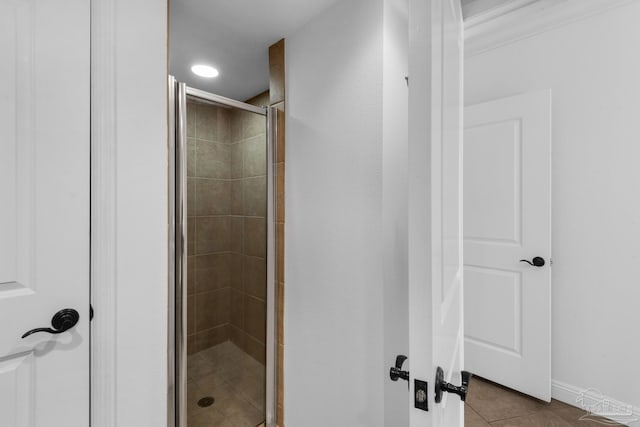 bathroom with tile patterned flooring and walk in shower