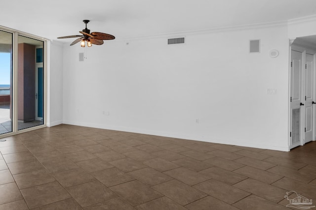 empty room with ornamental molding and ceiling fan