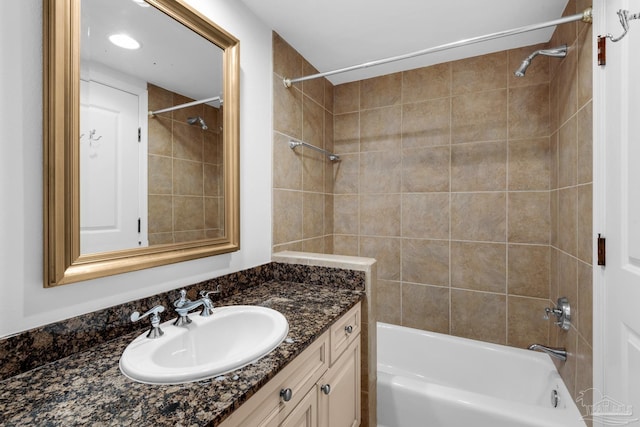 bathroom with vanity and tiled shower / bath