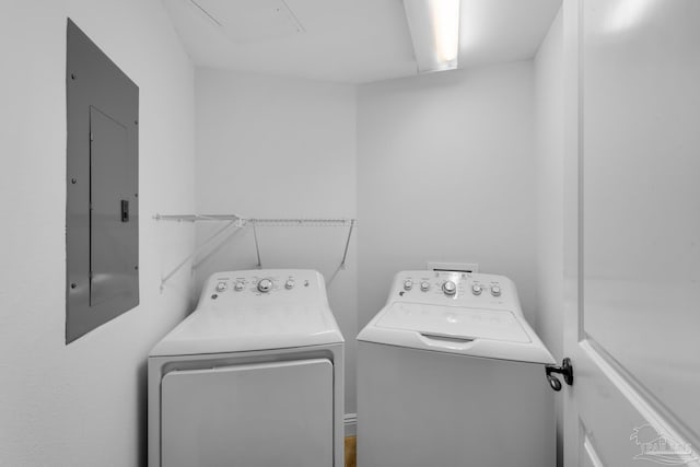 washroom with separate washer and dryer and electric panel