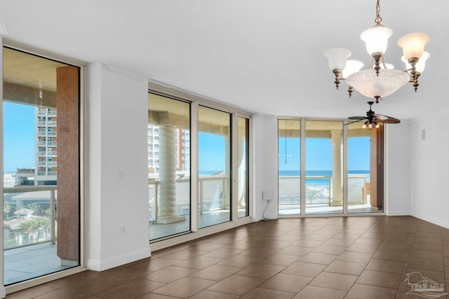 tiled spare room with floor to ceiling windows, ceiling fan with notable chandelier, crown molding, and a water view