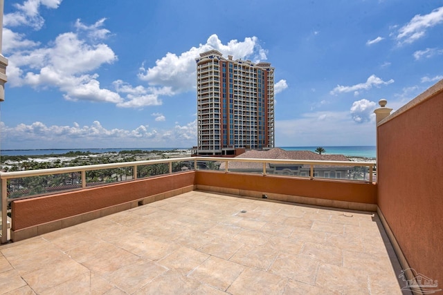 view of patio / terrace featuring a view of the beach and a water view