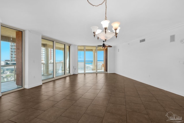 spare room featuring ceiling fan with notable chandelier, ornamental molding, a water view, and expansive windows